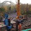Construction of the retaining wall on Dame Dorothy Street to facilitate future road widening. Sheet piles are being pushed 13 metres into the ground to support the widened road.